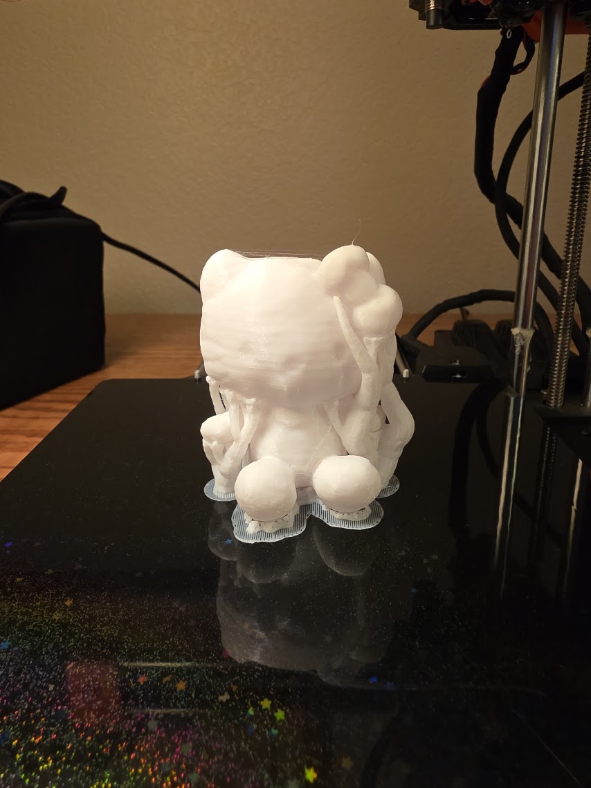 A white figurine straight off the 3D printer bed