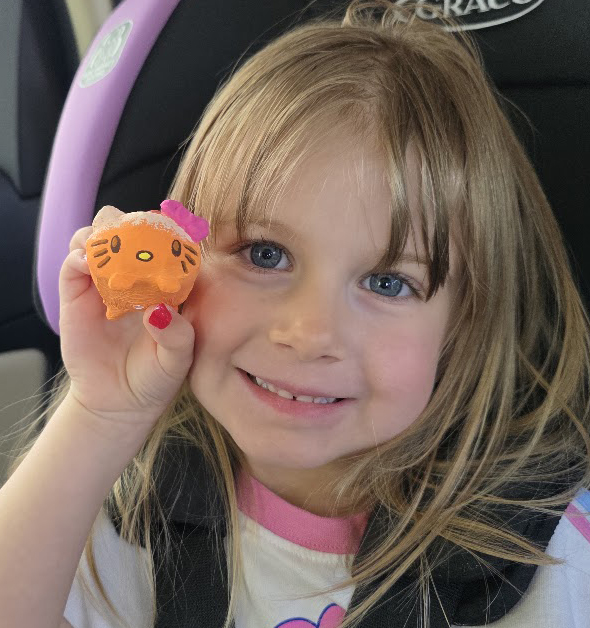 Our first fan holding up her painted Loaf Kitty mini in the car