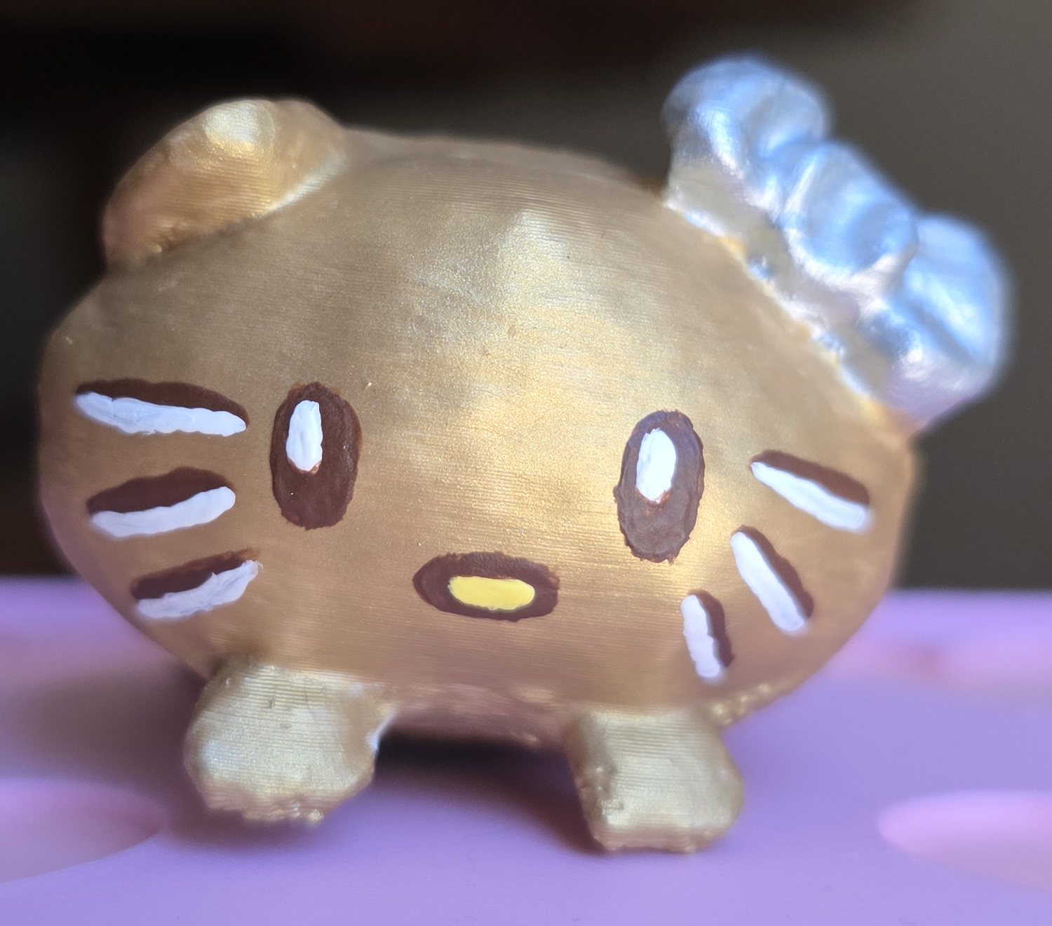 The Gold Nugget Loaf Kitty mini painted gold, straight-on front view