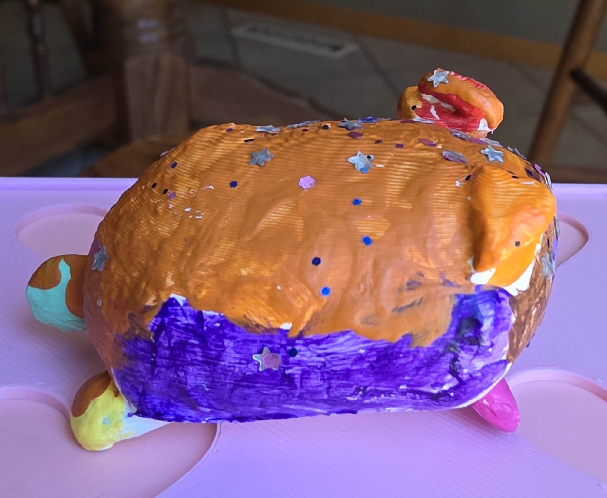 The Rainbow Loaf Kitty mini painted in rainbow colors, side view