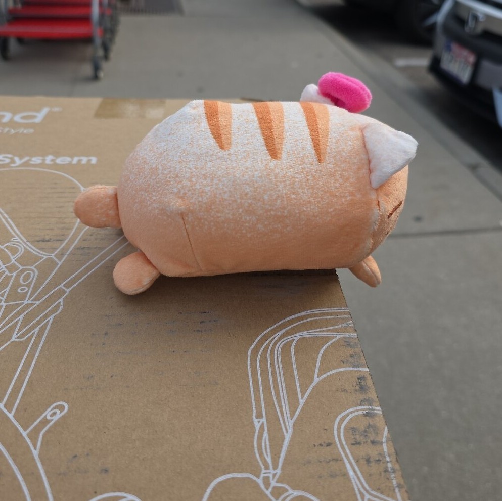 The loaf cat plush in side profile during its capture shoot
