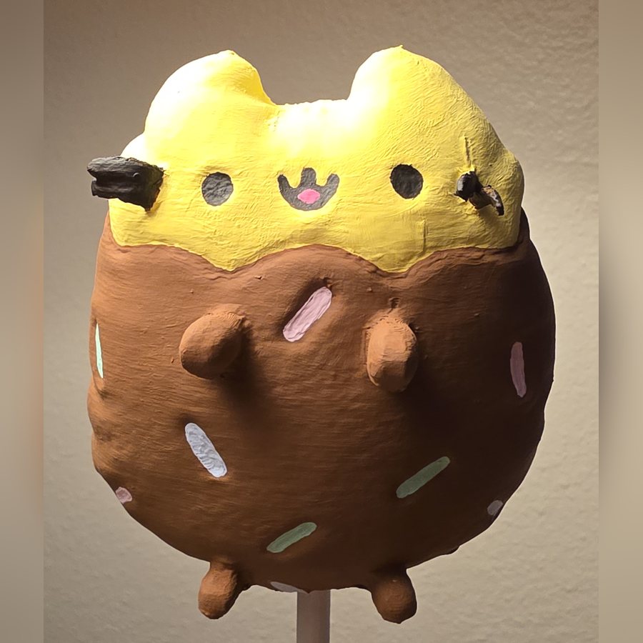 A finished mini painted like a chocolate-dipped treat with sprinkles